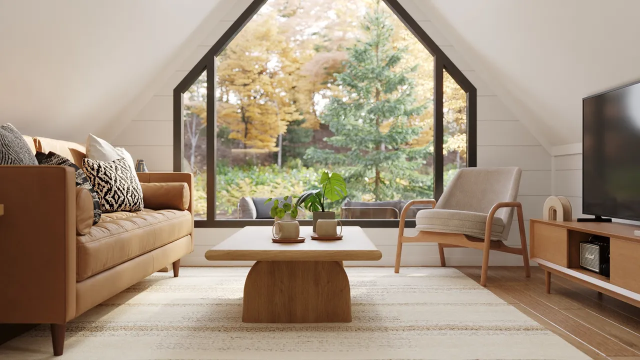 Interior view of an A-frame cabin with white walls and wooden celing featuring contemporary furniture.